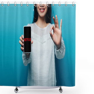 Personality  KYIV, UKRAINE - JULY 15, 2019: Cropped View Of Smiling Asian Woman In White Blouse Showing Ok Sign And Smartphone With Netflix App On Blue Background Shower Curtains