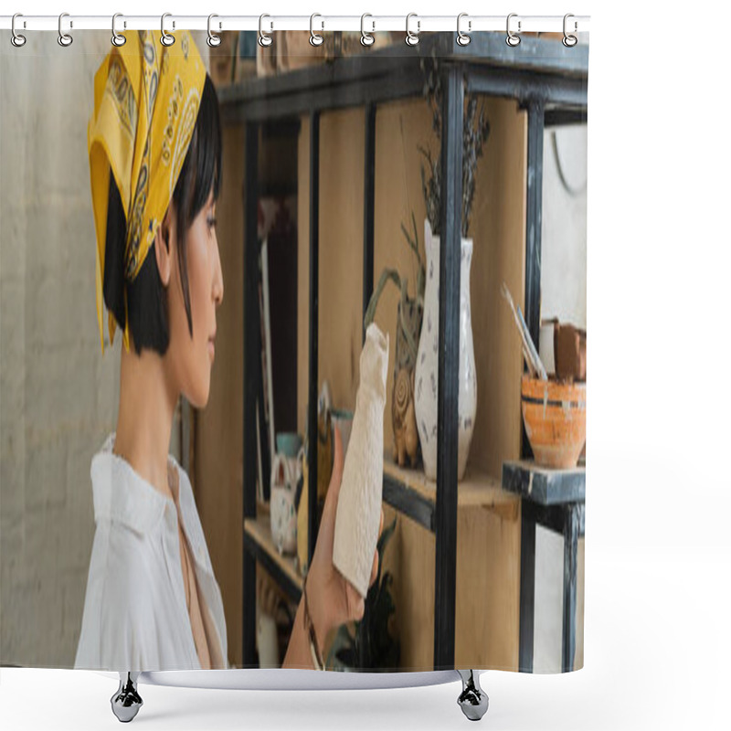 Personality  Side View Of Young Brunette Asian Female Potter In Headscarf And Workwear Holding Clay Sculpture Near Shelves In Ceramic Workshop At Background, Creative Process Of Pottery Making, Banner  Shower Curtains