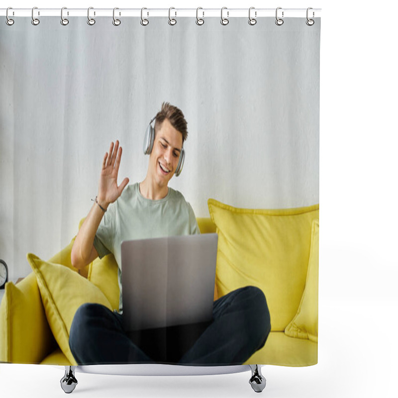 Personality  handsome young man with headphones and laptop in yellow couch saying hello to online meeting shower curtains