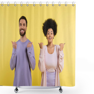 Personality  Cheerful Interracial Couple Pointing With Thumbs And Looking At Camera Isolated On Yellow Shower Curtains