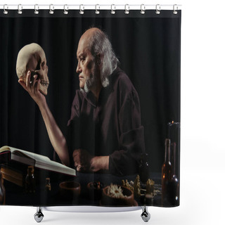 Personality  Senior Alchemist Looking At Skull Near Magic Cookbook And Herbal Ingredients Isolated On Black Shower Curtains