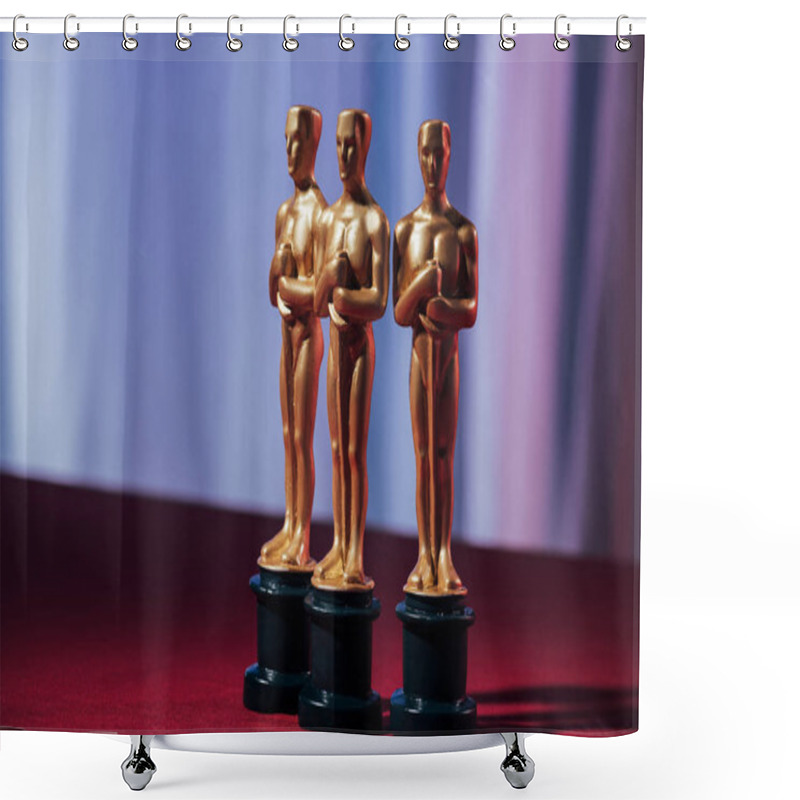 Personality  KYIV, UKRAINE - JANUARY 10, 2019: Selective Focus Of Golden Oscar Award Statuettes With Purple Background Shower Curtains