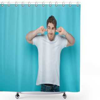 Personality  Displeased Young Man Plugging Ears With Fingers While Looking Away On Blue Background Shower Curtains