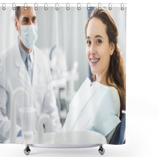 Personality  Selective Focus Of Woman In Braces Smiling With Dentist Standing In Mask On Background Shower Curtains