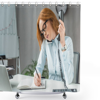 Personality  Redhead Businesswoman With Handset Talking On Mobile Phone, While Writing In Notebook At Workplace On Blurred Background Shower Curtains