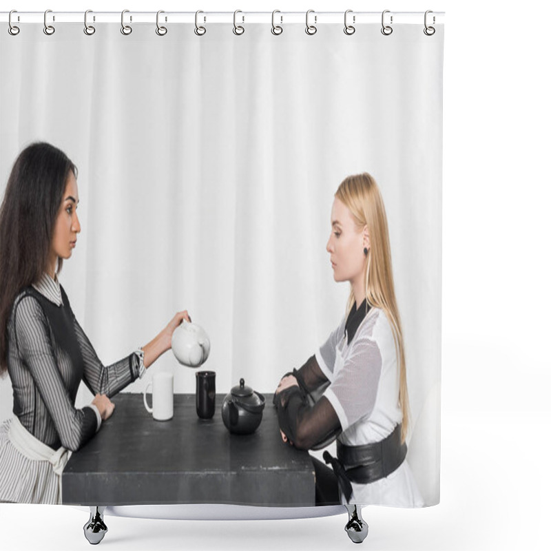 Personality  Side View Of Attractive Multiethnic Women In Black And White Clothes Sitting At Table With Teapots And Cups Isolated On White Shower Curtains