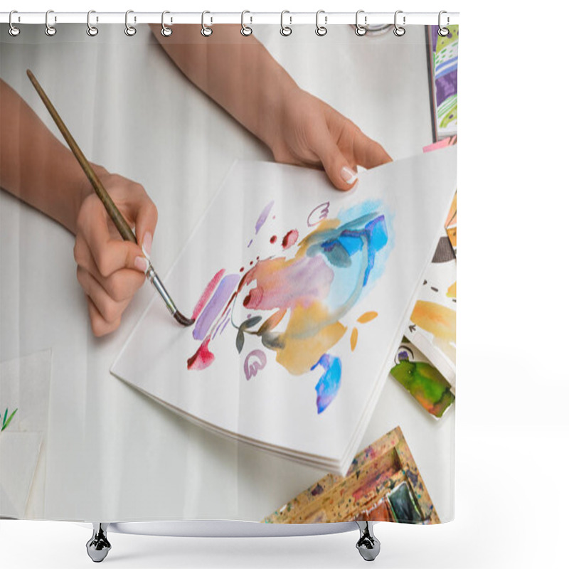Personality  selective focus of female hands painting with watercolors paints and paintbrush on white paper shower curtains