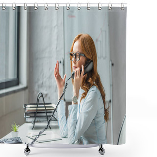Personality  Redhead Businesswoman Gesturing And Talking On Landline Telephone, While Sitting At Workplace On Blurred Background Shower Curtains