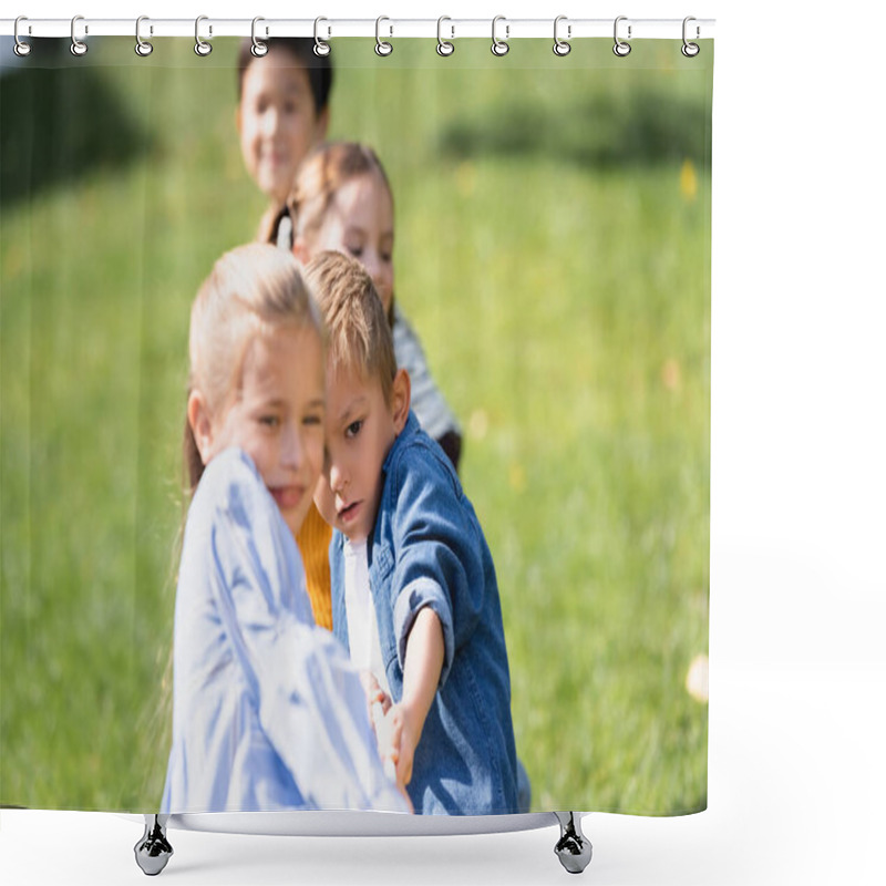 Personality  Boy Pulling Rope While Playing Tug Of War With Friends On Blurred Foreground In Park  Shower Curtains