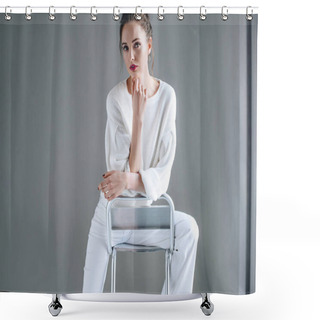 Personality  Portrait Of Beautiful Brunette Woman In Trendy White Clothes Sitting On Chair And Looking At Camera On Grey  Shower Curtains