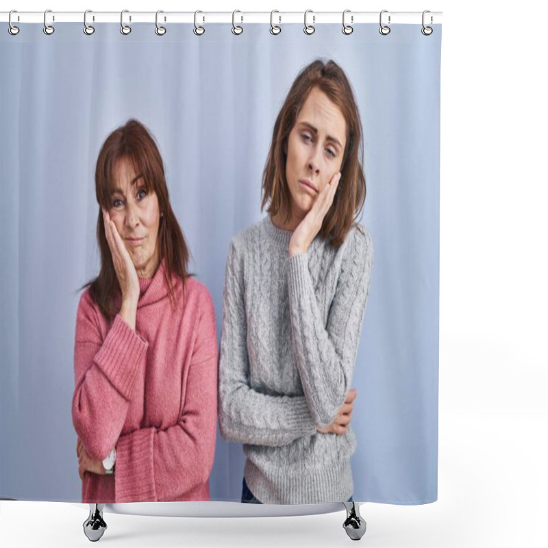 Personality  Mother and daughter standing over blue background thinking looking tired and bored with depression problems with crossed arms.  shower curtains