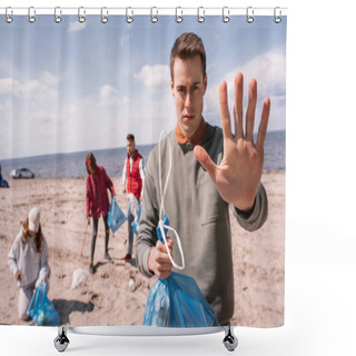 Personality  Young Man Showing Stop Gesture Near Blurred Group Of Volunteers Picking Up Trash, Ecology Concept  Shower Curtains