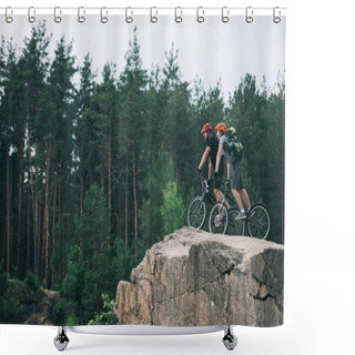 Personality  Distant View Of Male Extreme Cyclists In Protective Helmets Riding On Mountain Bicycles On Rocky Cliff In Forest Shower Curtains