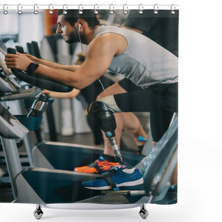 Personality  Side View Of Handsome Young Sportsman With Artificial Leg Working Out On Stationary Bicycle At Gym Shower Curtains