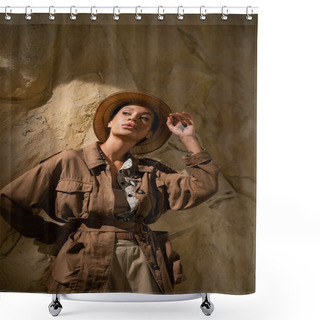 Personality  Young Archaeologist Adjusting Safari Hat And Looking Away Near Rock In Desert Shower Curtains