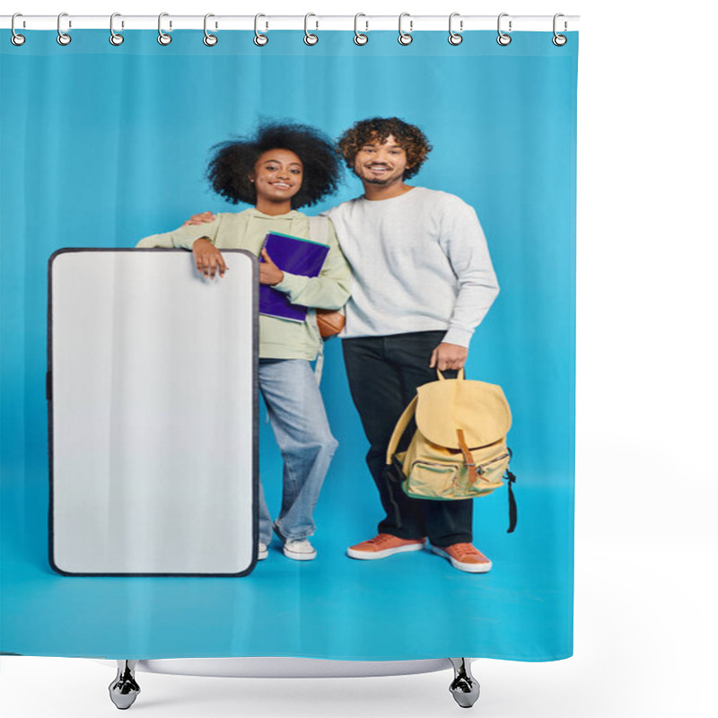 Personality  A Diverse Couple Of Students Standing Next To A Smartphone Mockup In A Studio With A Blue Background. Shower Curtains