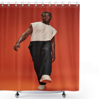 Personality  Full Length Of Charismatic And Fashionable African American Man Posing With Outstretched Leg On Red Shower Curtains