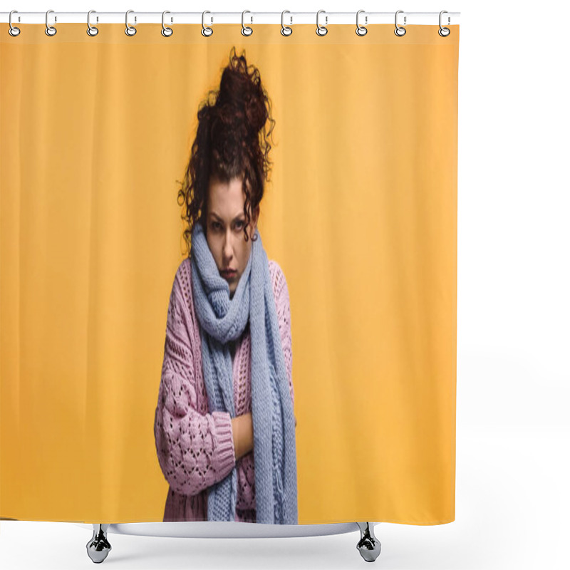 Personality  displeased woman freezing in warm sweater and scarf isolated on orange shower curtains
