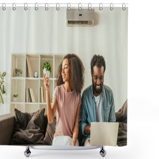 Personality  Smiling African American Man Using Laptop While Sitting On Sofa Near Cheerful African American Woman Holding Air Conditioner Remote Controller Shower Curtains