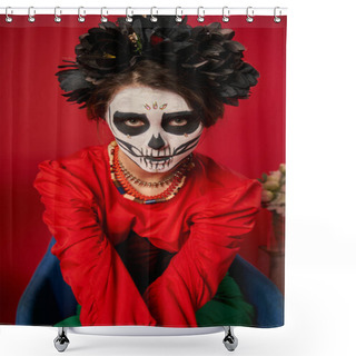 Personality  Woman In Scary Sugar Skull Makeup And Colorful Beads Looking At Camera In Armchair On Red Shower Curtains