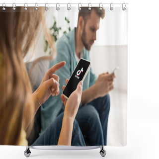 Personality  KYIV, UKRAINE - FEBRUARY 21, 2020: Selective Focus Of Woman Pointing With Finger At Smartphone With TikTok App Near Boyfriend Chatting On Couch  Shower Curtains