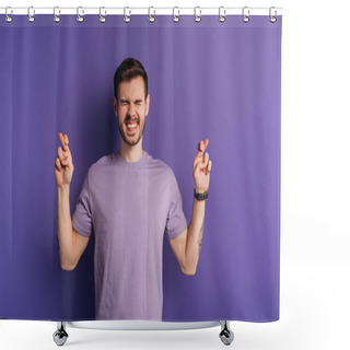Personality  Excited Young Man Holding Crossed Fingers While Standing With Closed Eyes On Purple Background Shower Curtains