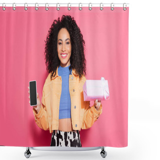 Personality  Curly African American Woman In Crop Top And Jacket Holding Smartphone With Blank Screen And Present On Pink  Shower Curtains