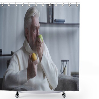 Personality  Elderly Man With A Gray Beard Sniffs Lemon And Apple And Does Not Smell Shower Curtains