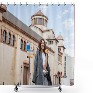 Personality  Positive Young Woman In Casual Grey Jacket Holding Fresh Orange And Leash While Looking At Camera With Historical Landmark At Background On City Street In Barcelona, Spain, Ancient Building  Shower Curtains