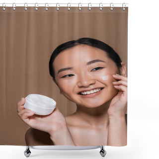 Personality  Positive Asian Woman With Naked Shoulders Applying Face Cream Isolated On Brown  Shower Curtains