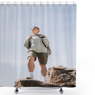 Personality  Low Angle View Of Confident Young Short Haired Female Tourist With Fitness Tracker And Backpack Standing On Stones And Looking Away With Blue Sky At Background, Vibrant Travel Experiences Shower Curtains