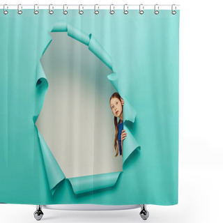 Personality  Scared Red Haired Preteen Girl In Blue T-shirt Looking At Camera While Standing Behind Hole In Blue Paper On White Background Background Shower Curtains