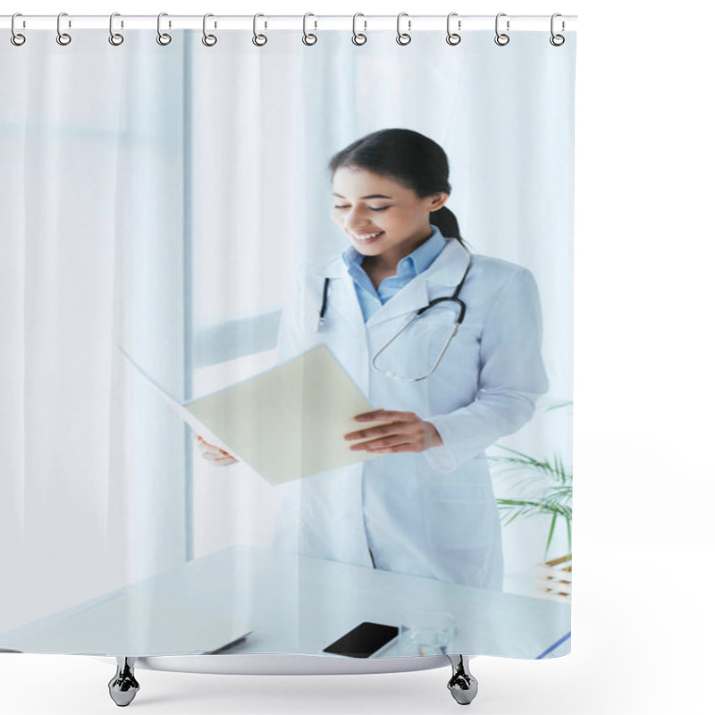 Personality  Smiling Latin Doctor Holding Paper Folder While Standing By Window In Hospital Shower Curtains