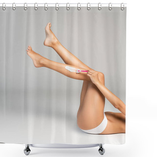 Personality  Cropped View Of Female Legs In Air Shaving Leg With Safety Razor And Cream, While Lying On Grey Shower Curtains