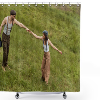 Personality  Side View Of Positive And Fashionable Couple In Newsboy Caps And Suspenders Holding Hands And Having Fun On Grassy Meadow At Background, Stylish Couple Enjoying Country Life Shower Curtains