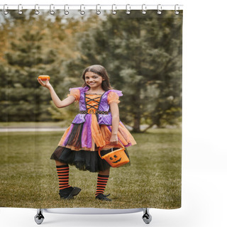 Personality  Cheerful Girl In Halloween Costume Holding Pumpkin And Bucket Of Candies On Green Grass Shower Curtains