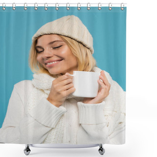 Personality  Pleased Young Woman In White Sweater And Hat Holding Cup Of Coffee Isolated On Blue  Shower Curtains