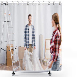 Personality  Smiling Young Man Looking At Woman While Covering Room With Polyethylene During Repair At Home Shower Curtains