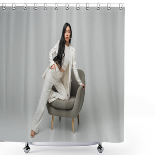 Personality  Full Length Of Young Asian Woman Leaning On Armchair While Posing With Hand In Pocket On Grey Shower Curtains
