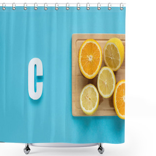 Personality  Top View Of Ripe Cut Lemon And Orange On Wooden Cutting Board Near Letter C On Blue Background Shower Curtains