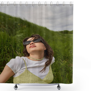 Personality  Portrait Of Trendy Brunette Woman In Sunglasses And Stylish Sundress Sitting And Relaxing On Blurred Grassy Hill With Blurred Landscape And Sky At Background, Natural Landscape Shower Curtains