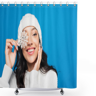 Personality  Cheerful Woman In Knitted Hat Holding Decorative Snowflake Near Eye Isolated On Blue Shower Curtains