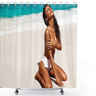 Personality  Portrait Of Beautiful Caucasian Sunbathed Woman Model With Dark Long In Swimsuit Sitting On Summer Beach With White Sand On Blue Sky And Ocean Background. Covering  Her Big Breast With Hand Shower Curtains