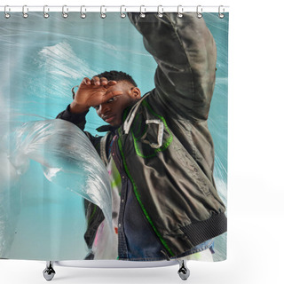 Personality  Stylish Afroamerican Model In Outwear Jacket With Led Stripes Covering Face While Looking At Camera Near Cellophane On Turquoise Background, Urban Outfit, Creative Expression, DIY Clothing  Shower Curtains