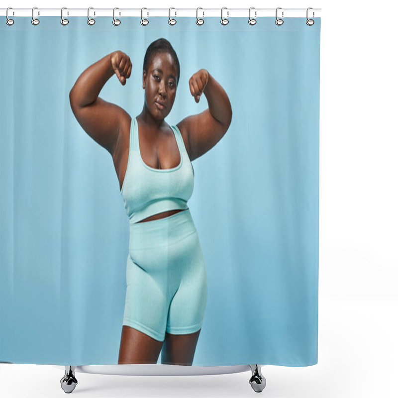 Personality  Serious Plus Size Woman In Active Wear Flexing Her Muscles And Looking At Camera On Blue Background Shower Curtains
