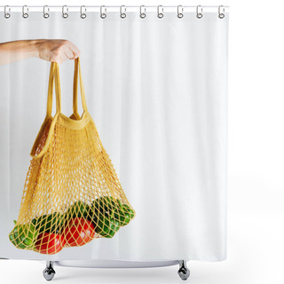 Personality  Female Hand Holding Yellow Mesh Bag With Vegetables On White Background Shower Curtains