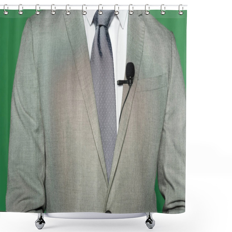 Personality  Cropped View Of News Anchor In Suit And Clip Microphone Standing On Green  Shower Curtains