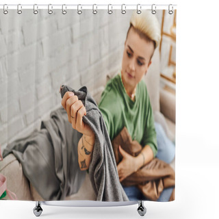 Personality  Young Tattooed Woman Sitting On Couch In Living Room And Holding Grey Pants While Reducing Wardrobe Items At Home, Trendy Hairstyle, Tattoo, Sustainable Living And Mindful Consumerism Concept Shower Curtains