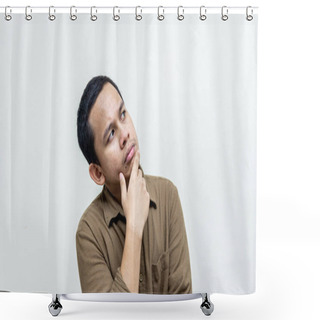 Personality  Confused And Thinking Face Expression Of Young Asian Malay Man With Hand On The Chin Looking On Empty Space With Casual Brown Shirt With Isolated White Background. Thinking Idea Concept. Shower Curtains