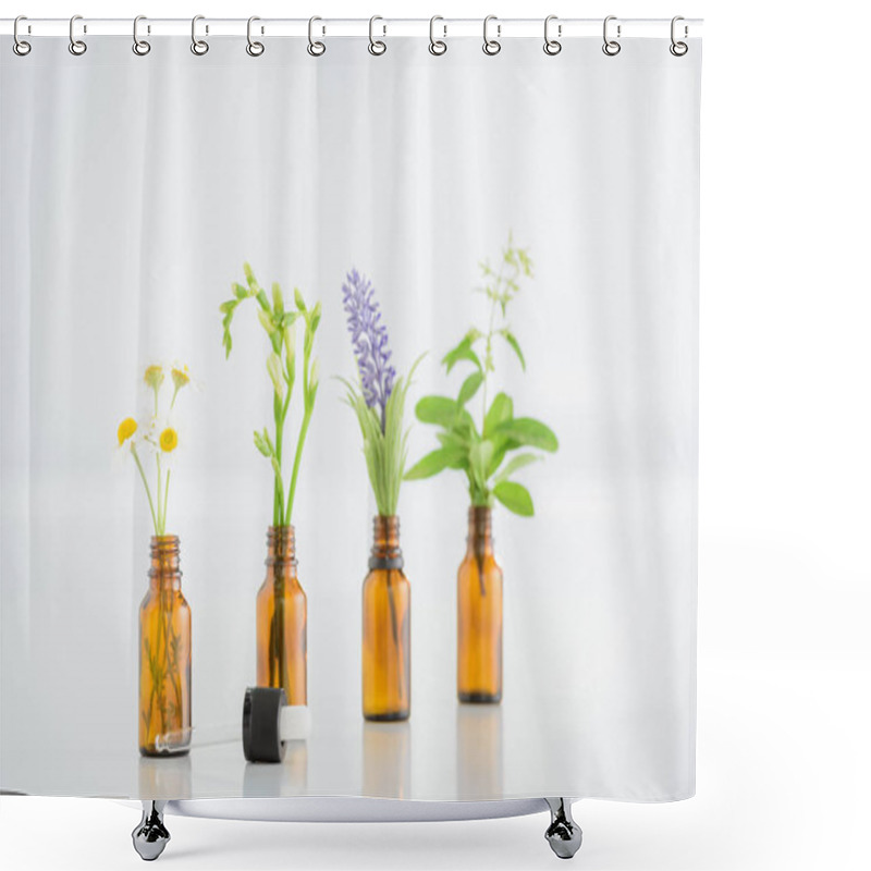 Personality  chamomile, freesia, salvia and hyacinth flowers in glass bottles near dropper on white background shower curtains